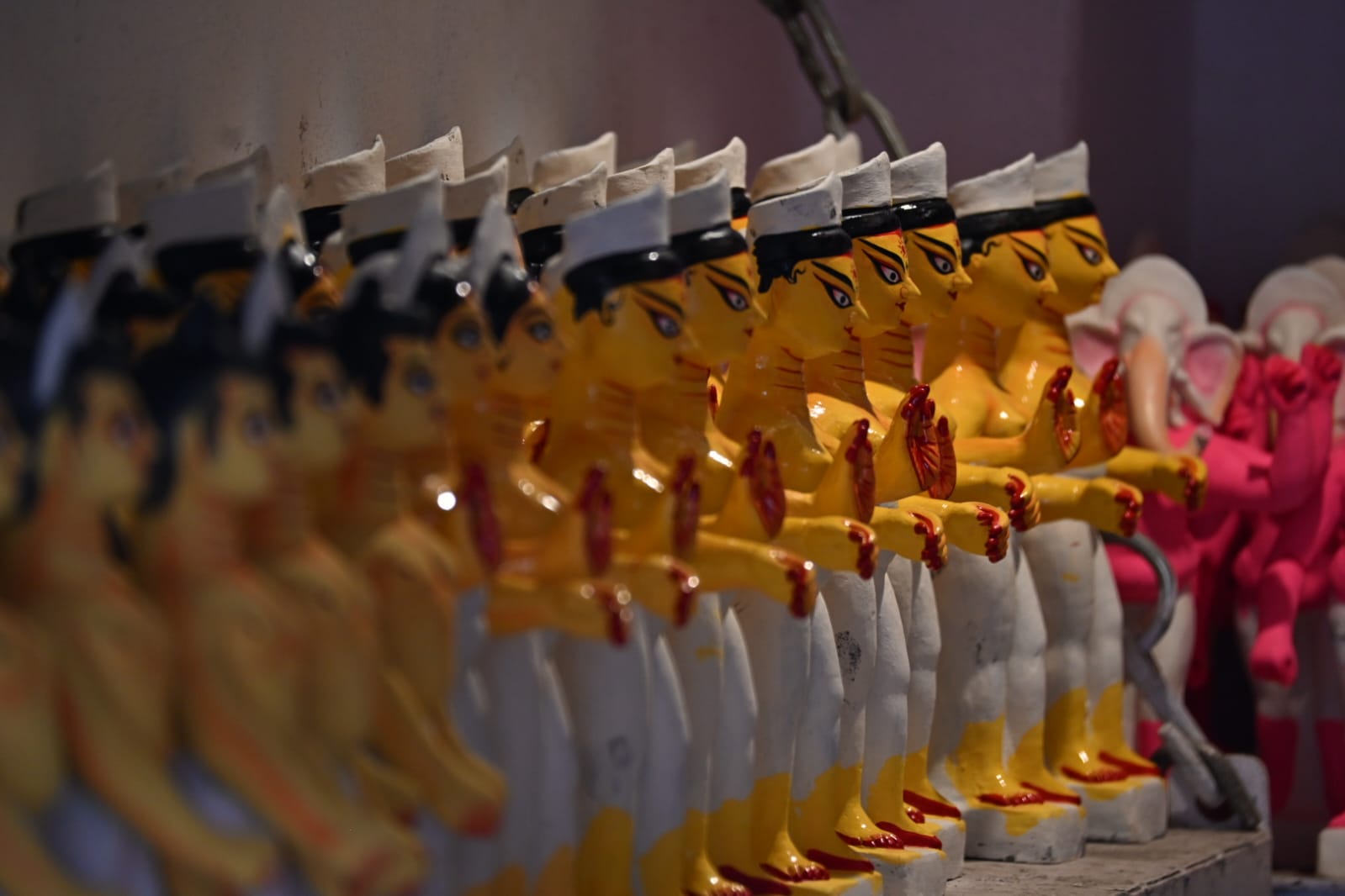 Rows of finished, brightly painted Durga figures